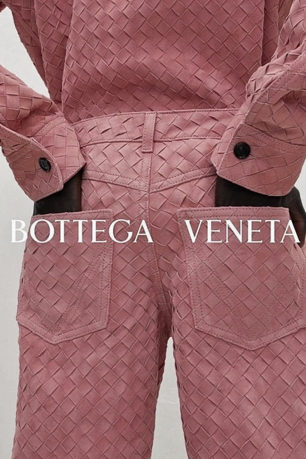 Dusty pink woven-texture outfit featuring a long-sleeve shirt and matching trousers with large front pockets.