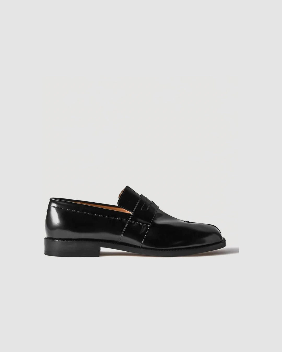Black Maison Margiela leather penny loafers with a polished finish and low heel, side view
